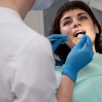 a woman is getting dental treatment.