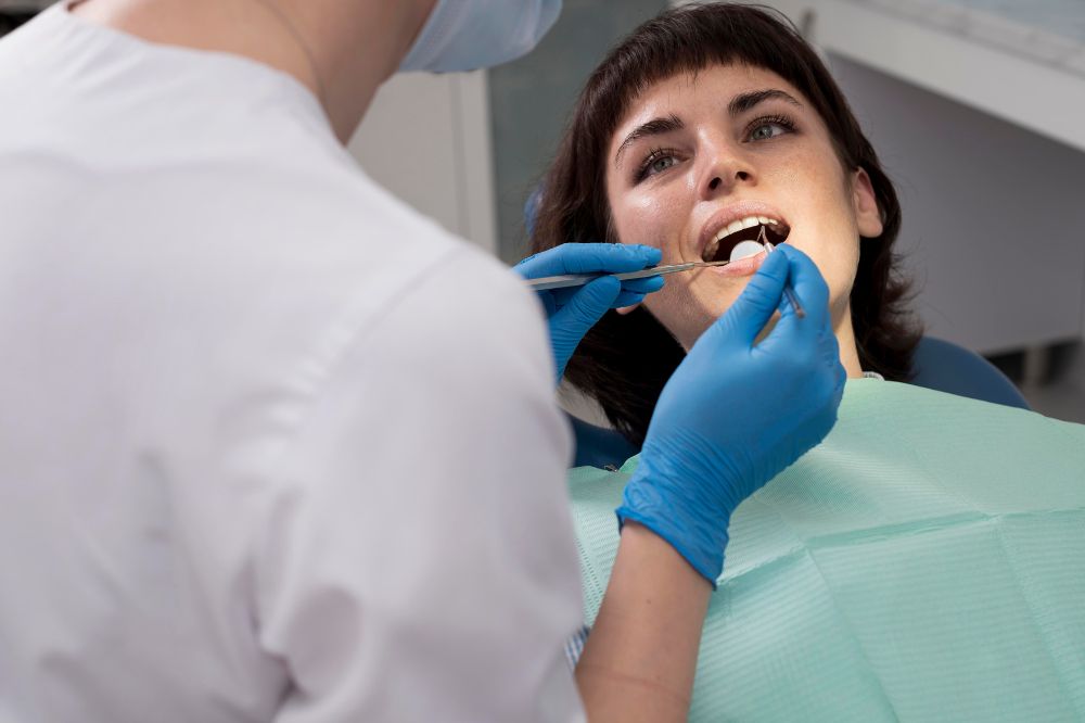 a woman is getting dental treatment.