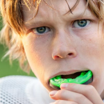 a boy is wearing a mouth guard