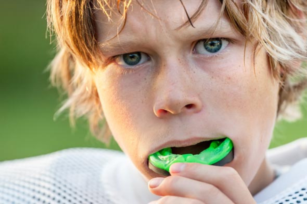 a boy is wearing a mouth guard
