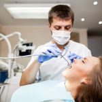 a woman is getting dental treatment