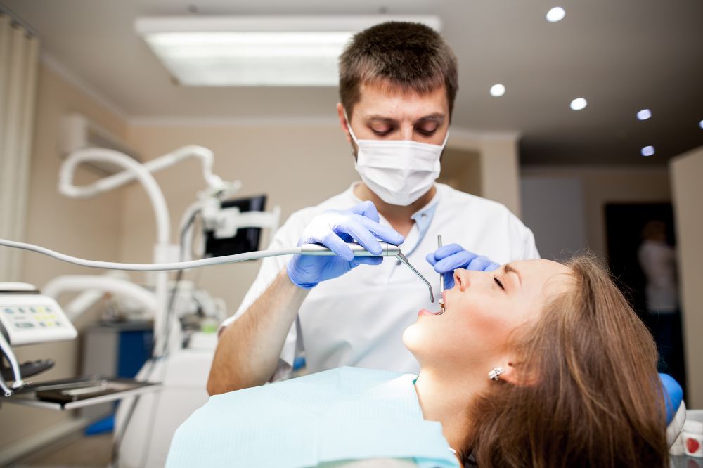 a woman is getting dental treatment